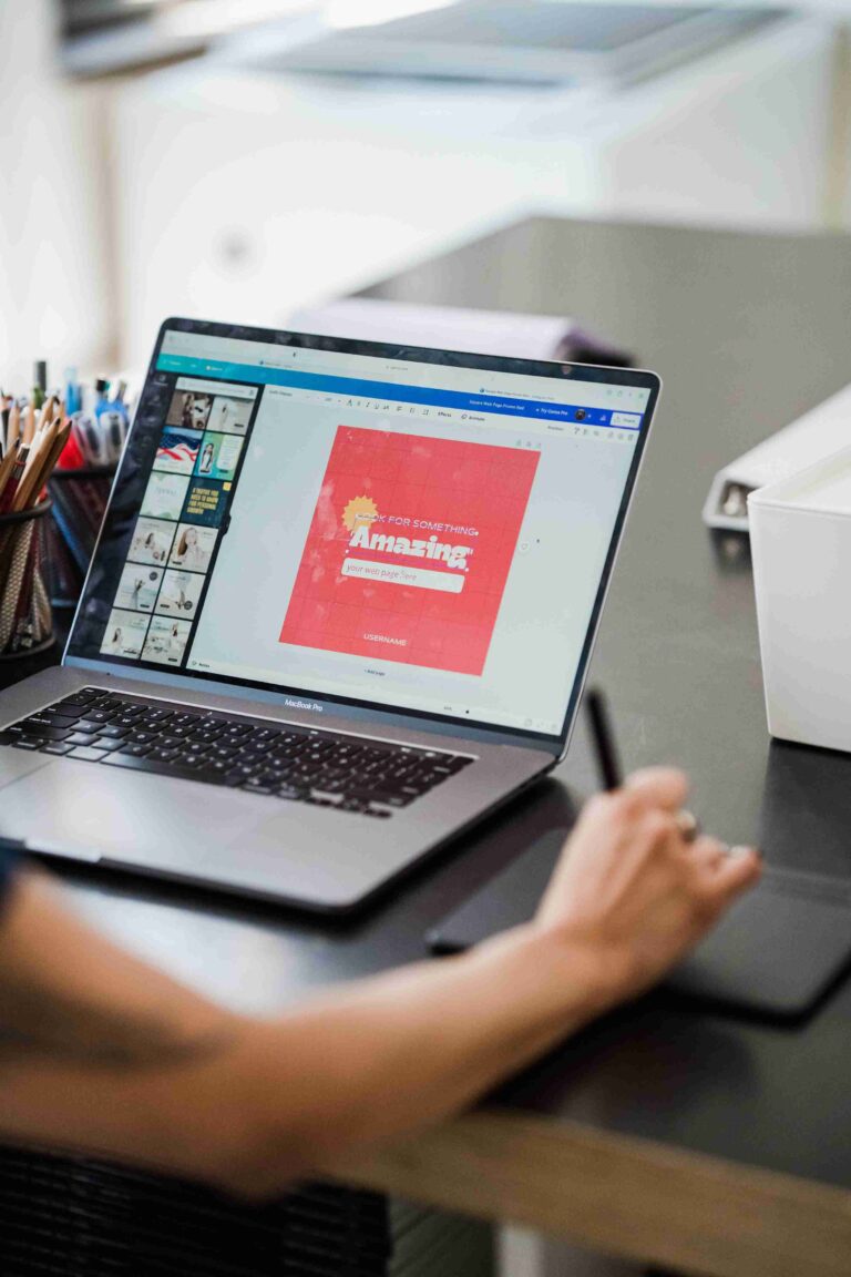 Designer editing a website layout on a laptop