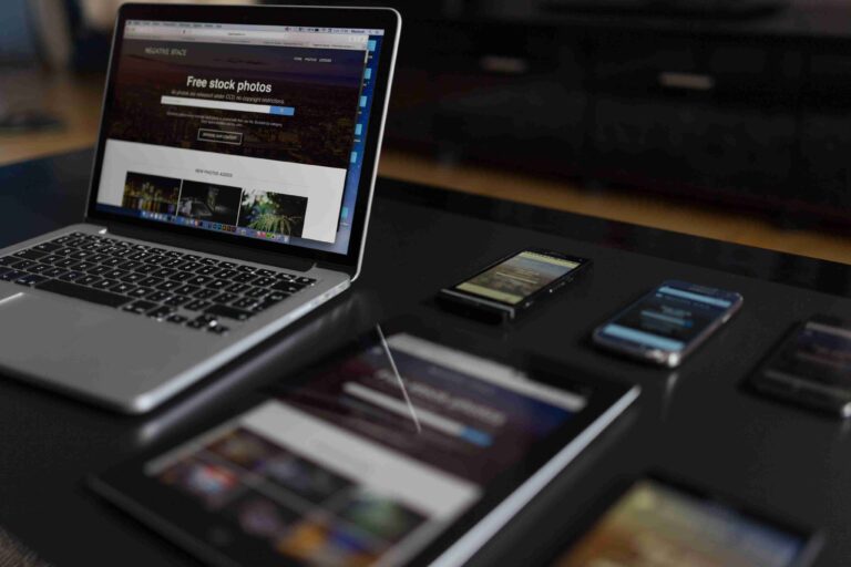 Laptop, tablet and phones displaying website layouts